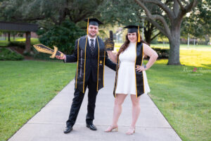 Two UCF Graduates, a guy and a girl posing for a photo with Khim Higgins Photography, a UCF graduation photographer