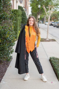 Oviedo High School senior girl wearing her cap and gown posing for Khim Higgins Photography.