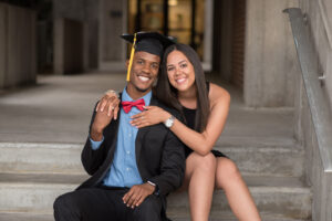 UCF graduate sitting on the stairs with his girlfriend.