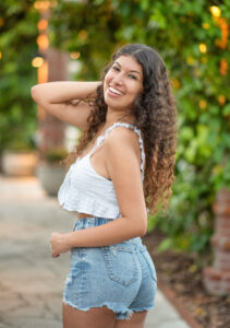 A lake mary senior girl looking back over her left shoulder.