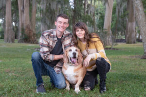 senior girl, her brother and her dog are kneeling down on lush green lawn for Khim Higgins Photography.