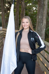 A senior girl from HHS is holding her dance flag as part of her senior shoot with Orlando Senior Photographer.