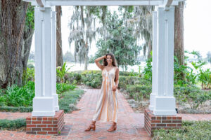 A senior girl from OHS is wearing a romper for her senior photo shoot with Orlando Senior Photographer, Khim Higgins.