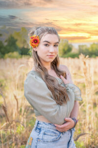 OHS senior photo shoot with Khim Higgins Photography of Mary standing in a field of tall grass in Baldwin park.