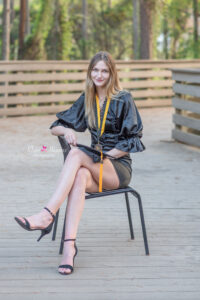 ucf graduate is sitting on a black chair at student union