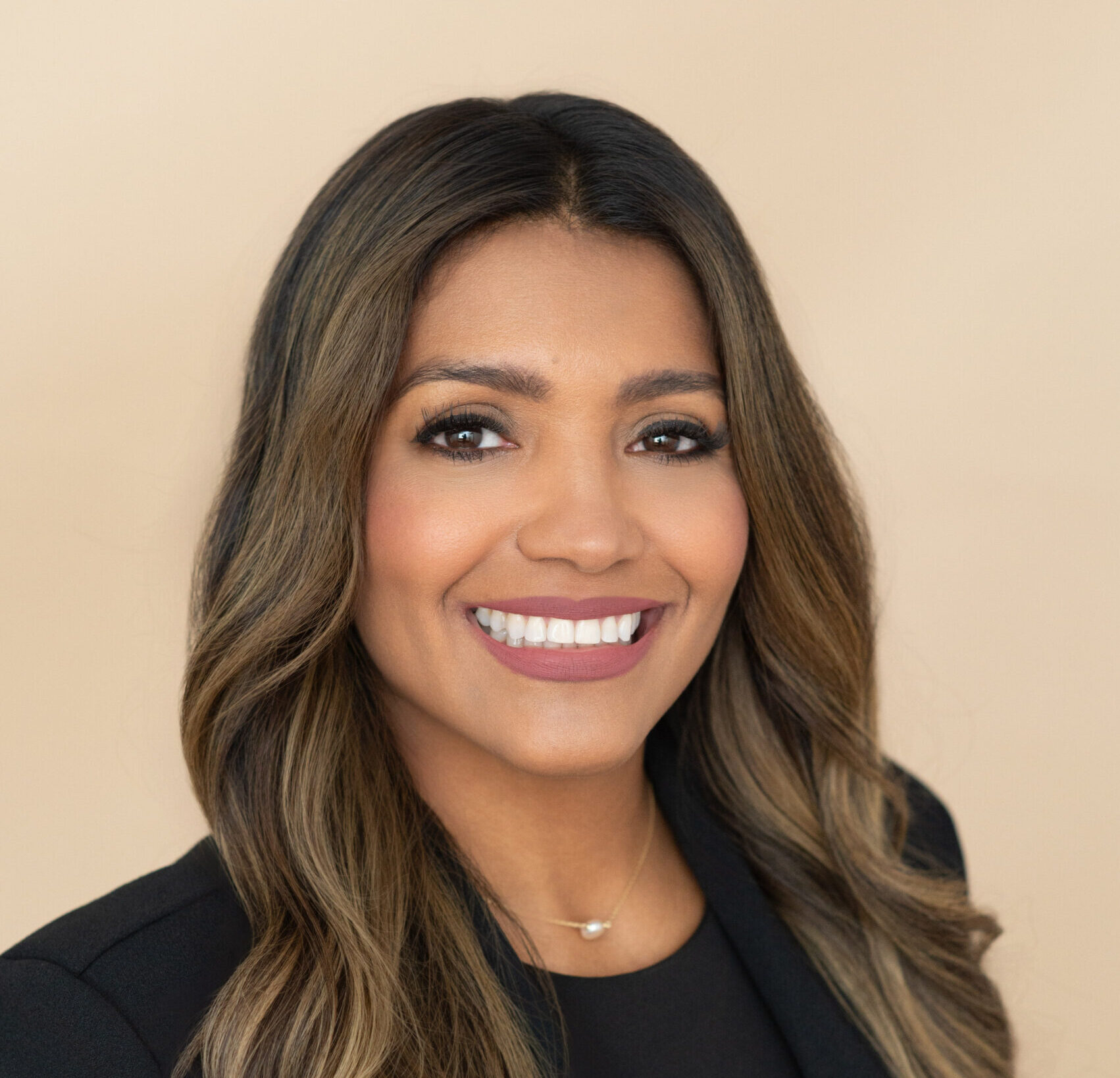 A beautiful brunette woman in a black jacket is smiling for a headshot photo with khim higgins photography in oviedo, florida.