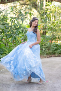 a sweet 16 girl is swaying back and forth while holding her dress at Leu Gardens with Khim higgins photography.