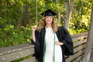 A ucf graduate is smiling at the boardwalk