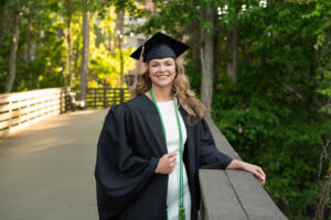 a ucf graduate in cap and gown at the boardwalk