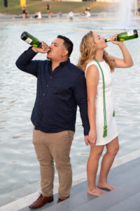 ucf grad and her boyfriend drinking champagne at the Reflecting Pond