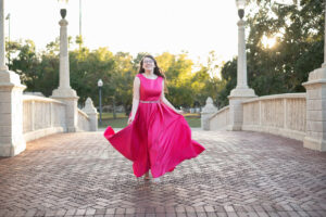 
oviedo-senior-high-school-girl-in-formal-dress-running-towards-Khim-Higgins-Photography