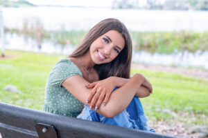 Ovieo senior girl on a bench by the lake in Orlando.
