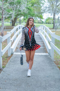 senior girl in dance outfit walks towards Oviedo senior photographer-Khim Higgins