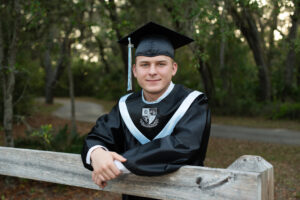 senior boy photo shoot in cap and gown with Oviedo photographer