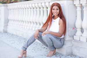 Senior girl sitting near the sidewalk