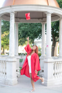 Senior girl tossing up graduation cap