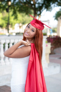 Cap and gown senior photo near sunset at Cranes Roost Park