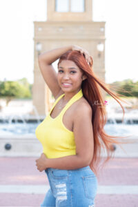 Senior girl standing in front of fountain 