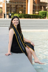 UCF Grad sits by the pond