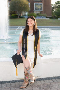 UCF senior girl sits by the pond
