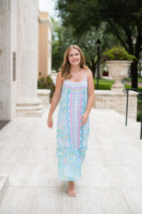 Orlando senior girl walking and smiling as Khim Higgins Photography takes her photos in Orlando.