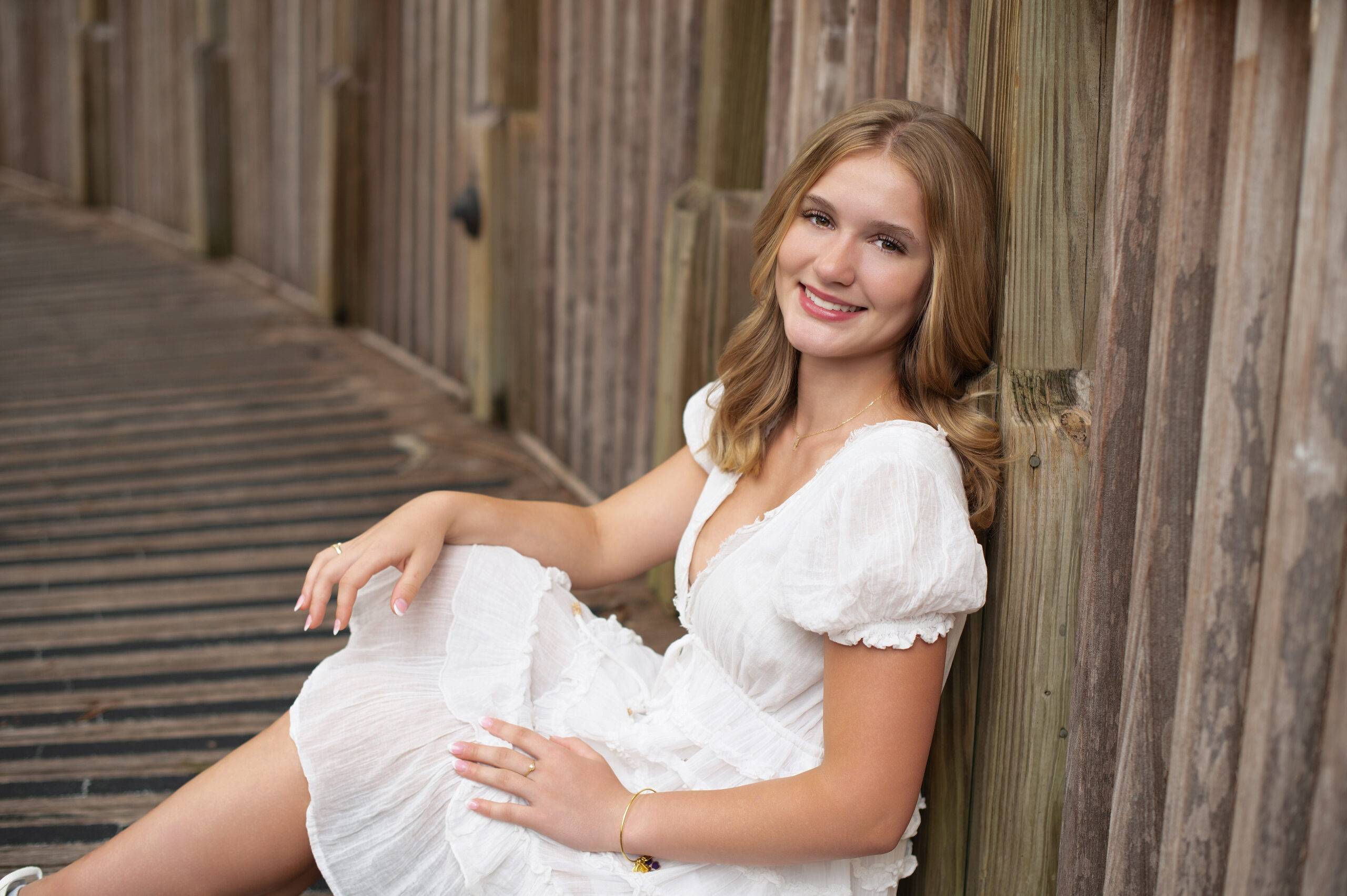 Oviedo senior girl sitting on a boardward in Orlando.