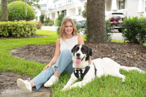 oviedo senior girl and her dog sitting on the grass in Oviedo.