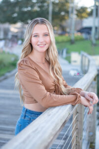 senior girl standing near the lake in Orlando