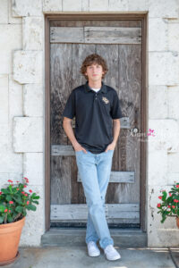 Senior boy photo shoot in Lake Mary with a clean, modern look near the lakeside, perfect for authentic portraits.