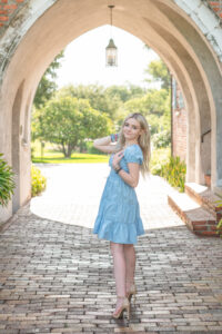 Senior girl standing near an archway in orlando