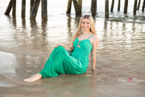 Senior girl sitting on the beach at sunrise, Orlando senior beach session