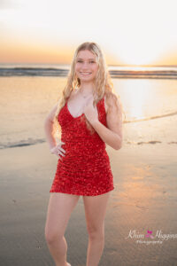 Senior girl standing by gentle waves at sunrise, Florida senior photography