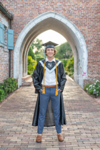 Orlando senior boy photographer taking senior pictures for a senior in his cap and gown.