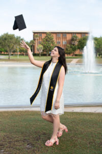UCF graduate tossing cap at Reflecting Pond Orlando