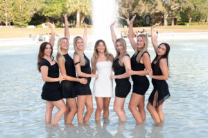 UCF graduate posing in Reflecting Pond Orlando photographer