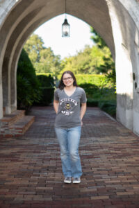 Senior girl standing under archway in Orlando