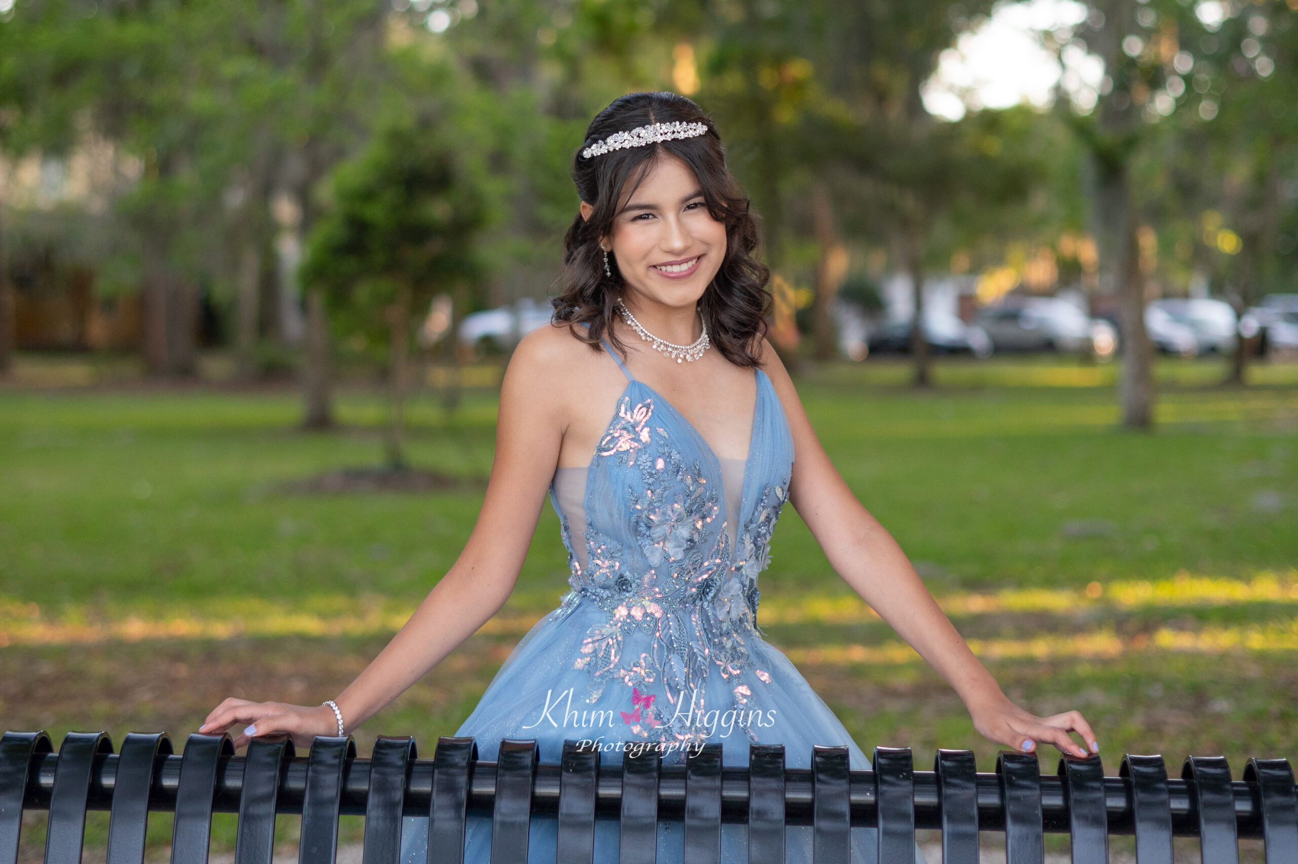 Elegant quinceañera portrait with traditional gown and natural background
