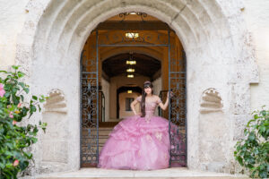Girl in a pink formal dress posing in Orlando for her quinceanera photo shoot