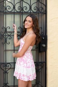 Oviedo senior girl wearing a pink and white dress smiling