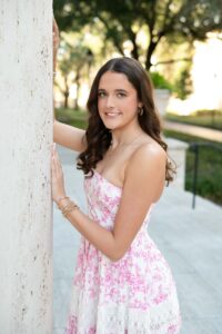 A natural portrait of an Oviedo senior smiling in her favorite casual outfit, highlighting her personality and style.