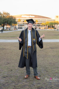 Graduation photo session at UCF Memory Mall featuring a graduate in cap and gown