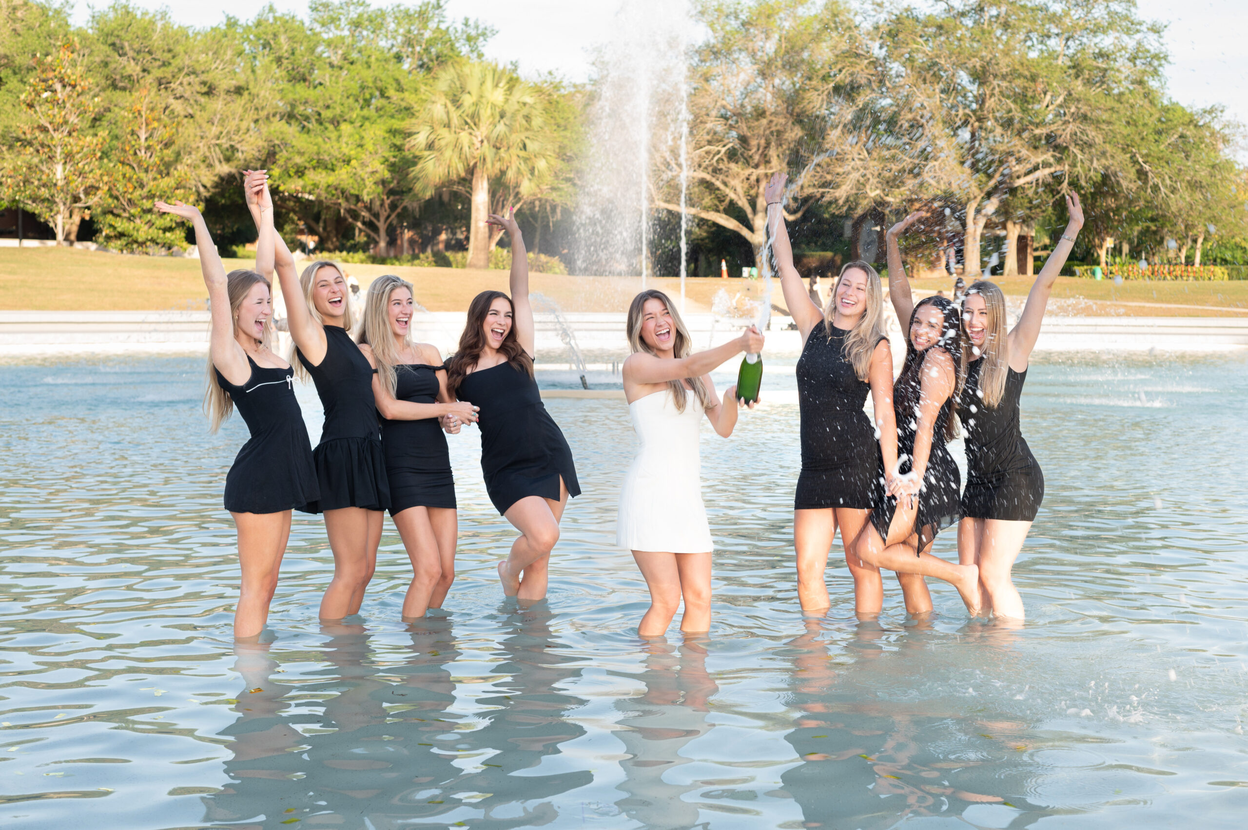 ucf grad with her sisters standing in the pond