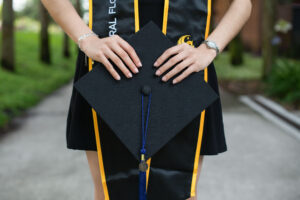 UCF graduation photographer capturing a graduate at Reflection Pond in Orlando