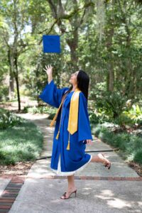 Senior girl tossing up her cap during an orlando senior photo shoot.