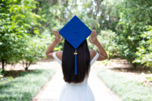 Orlando senior girl using her graduation cap as a prop during her senior photo shoot in Orlando.
